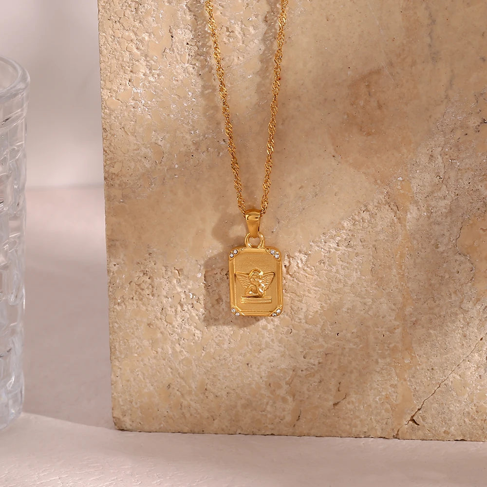 A gold-plated stainless steel necklace with a square pendant featuring an angel figure, surrounded by cubic zirconia on the corners.