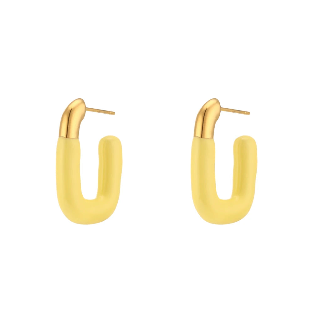 A pair of gold-colored hoop earrings with a pastel yellow coating.