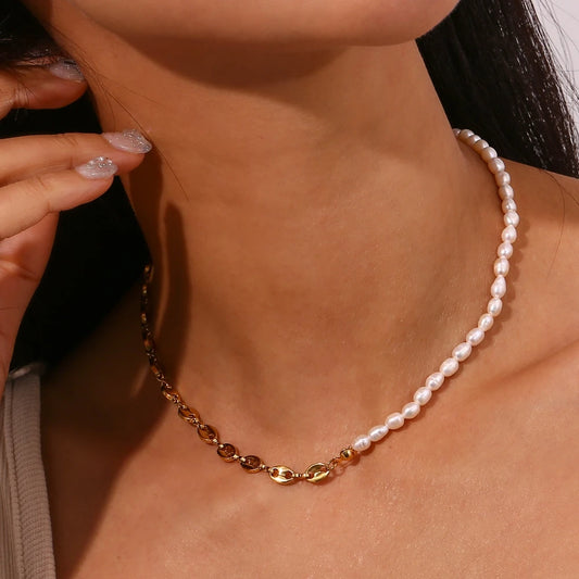 A pearl necklace with one half featuring gold-colored beads and the other half in freshwater pearls on a model's neck
