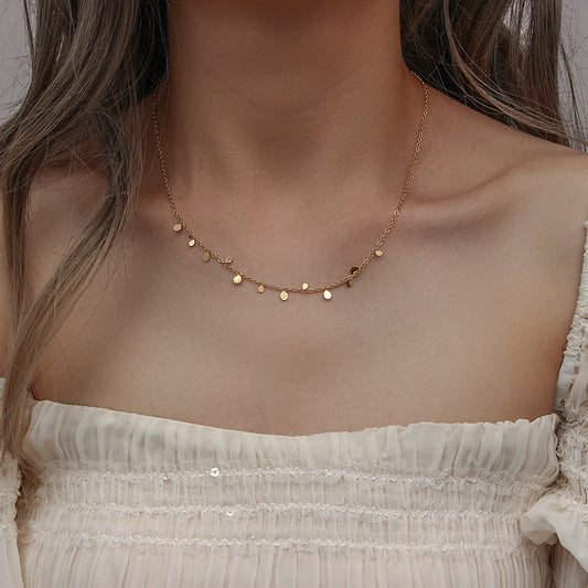 A gold-plated stainless steel necklace with multiple tiny discs attached to a chain, creating a shimmering effect.