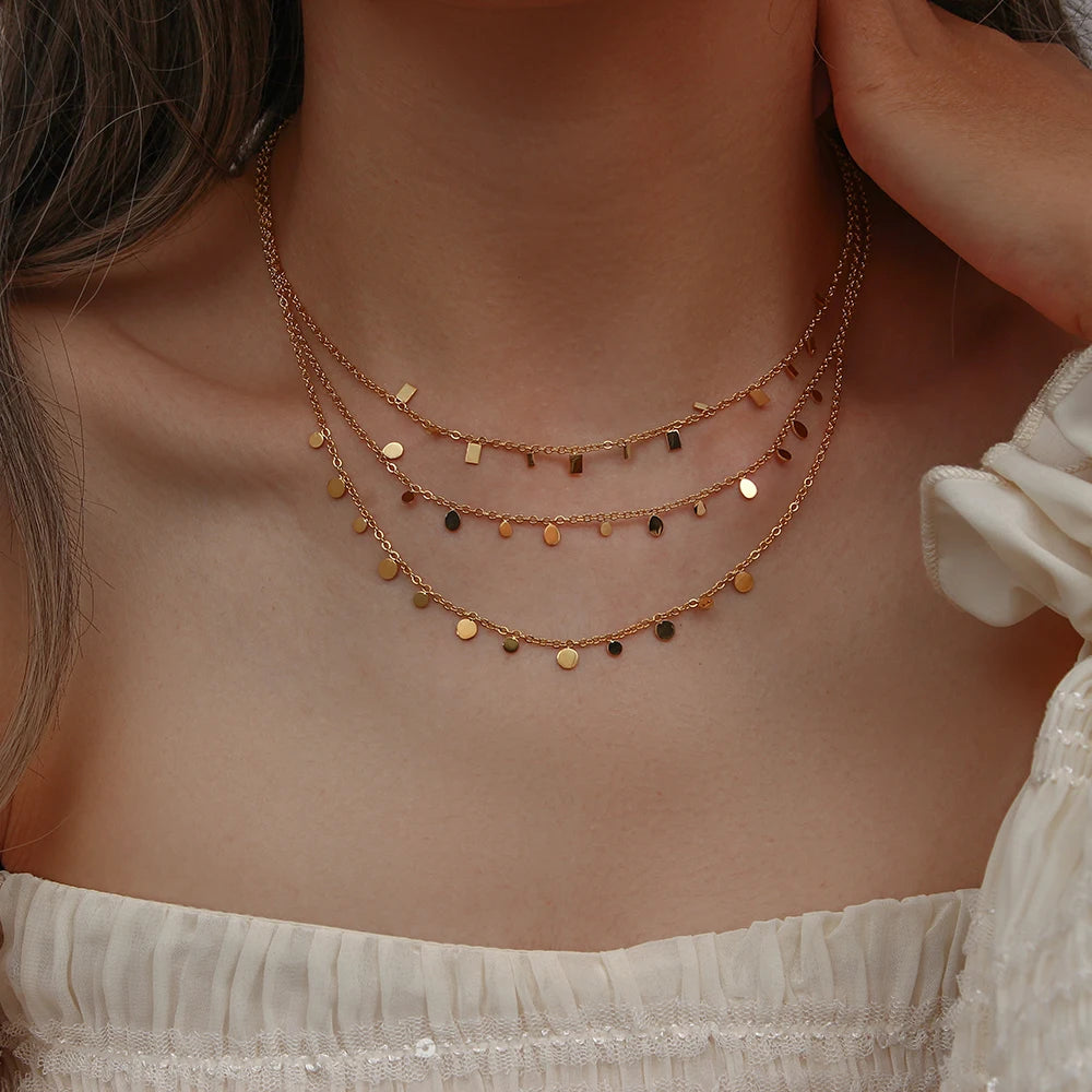 gold-plated stainless steel necklaces with multiple tiny discs attached to a chain, creating a shimmering effect.