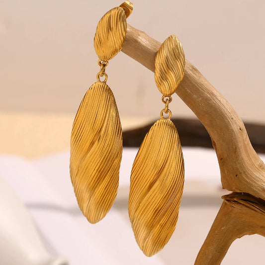 Goddess Lore Earrings displayed on branch