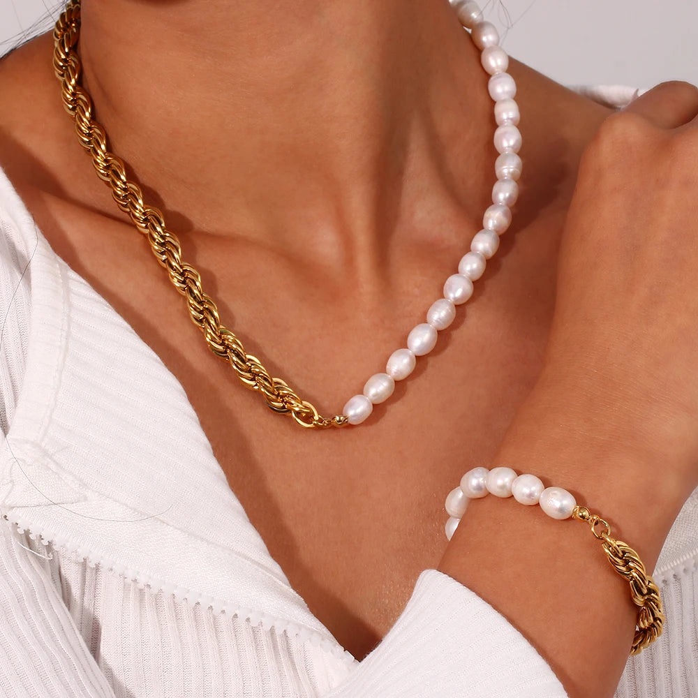Pearl necklace and bracelet on a person wearing a white top.