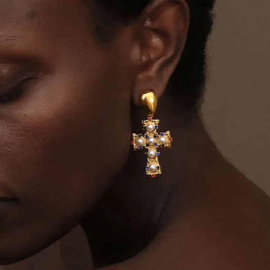 A pair of gold-plated earrings in the shape of a cross, adorned with multicolored zirconia and pearls.