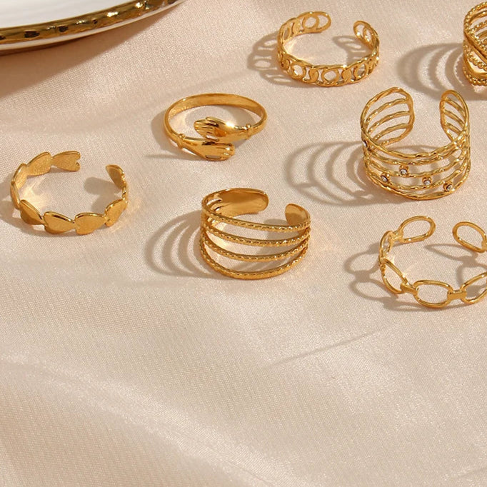 A gold-coated stainless steel ring with four bands that are merging into one,