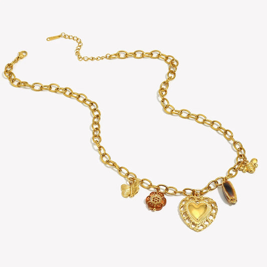 Gold bracelet with heart charm on a white background
