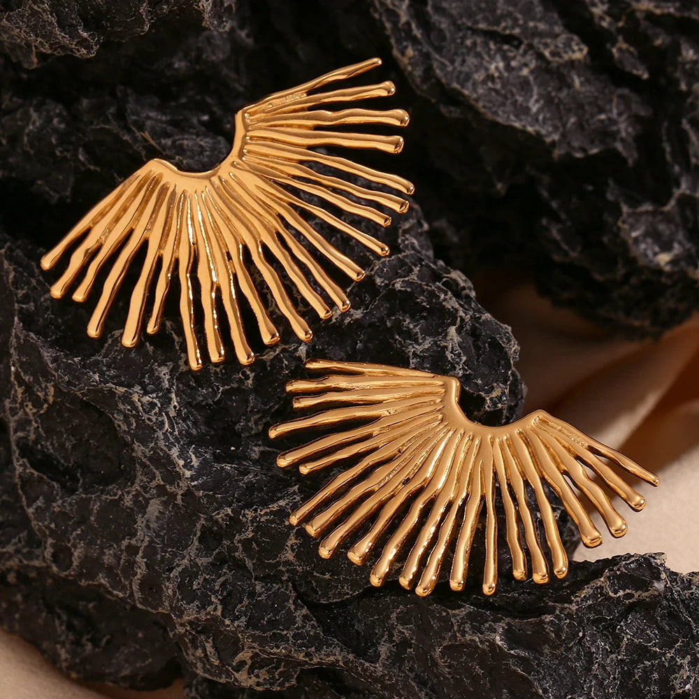 Solar ray Earrings in gold on black stone display