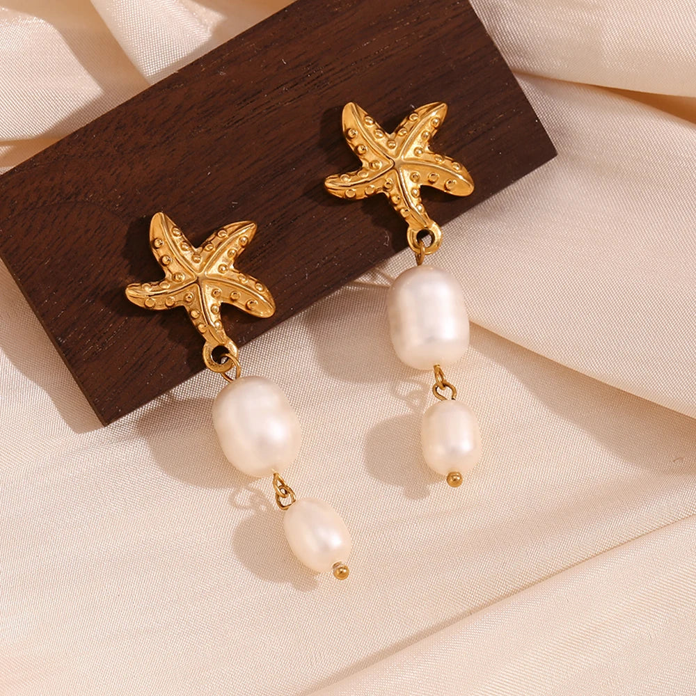 Star of The Sea Earrings on wooden display