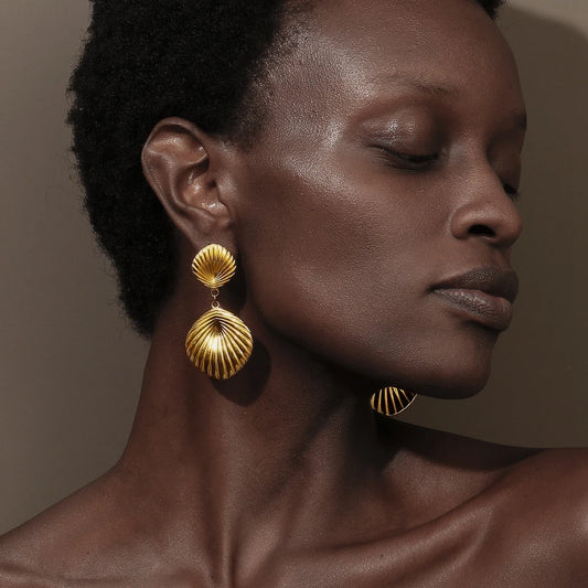 Tidal Grace shell shaped gold Earrings on model