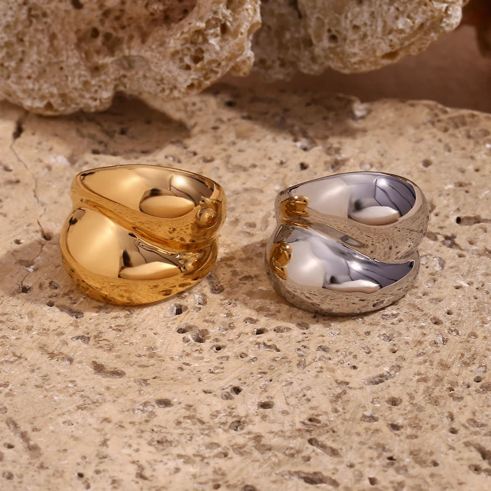Gold and silver chunky stainless steel rings with a smooth, flowing design, symbolizing strength and connection.