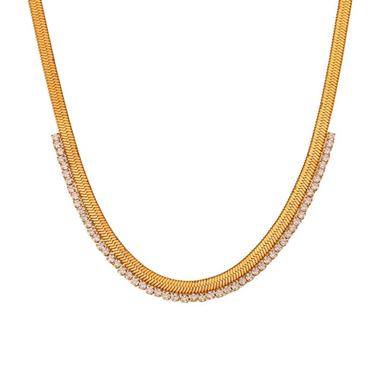A gold stainless steel necklace with a snake chain design and adorned with AAA zirconia in a curved pattern, providing a sparkling appearance.