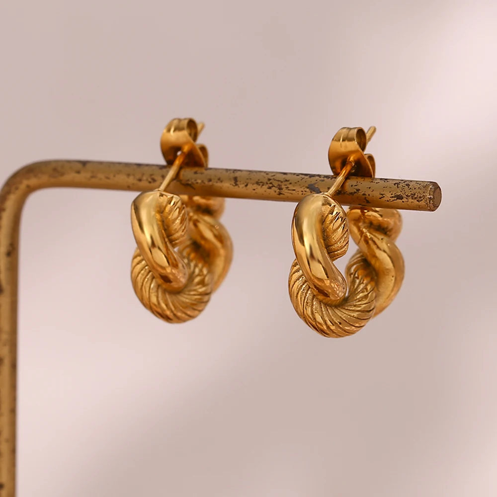 A pair of small, 18K gold plated twisted hoops earrings.