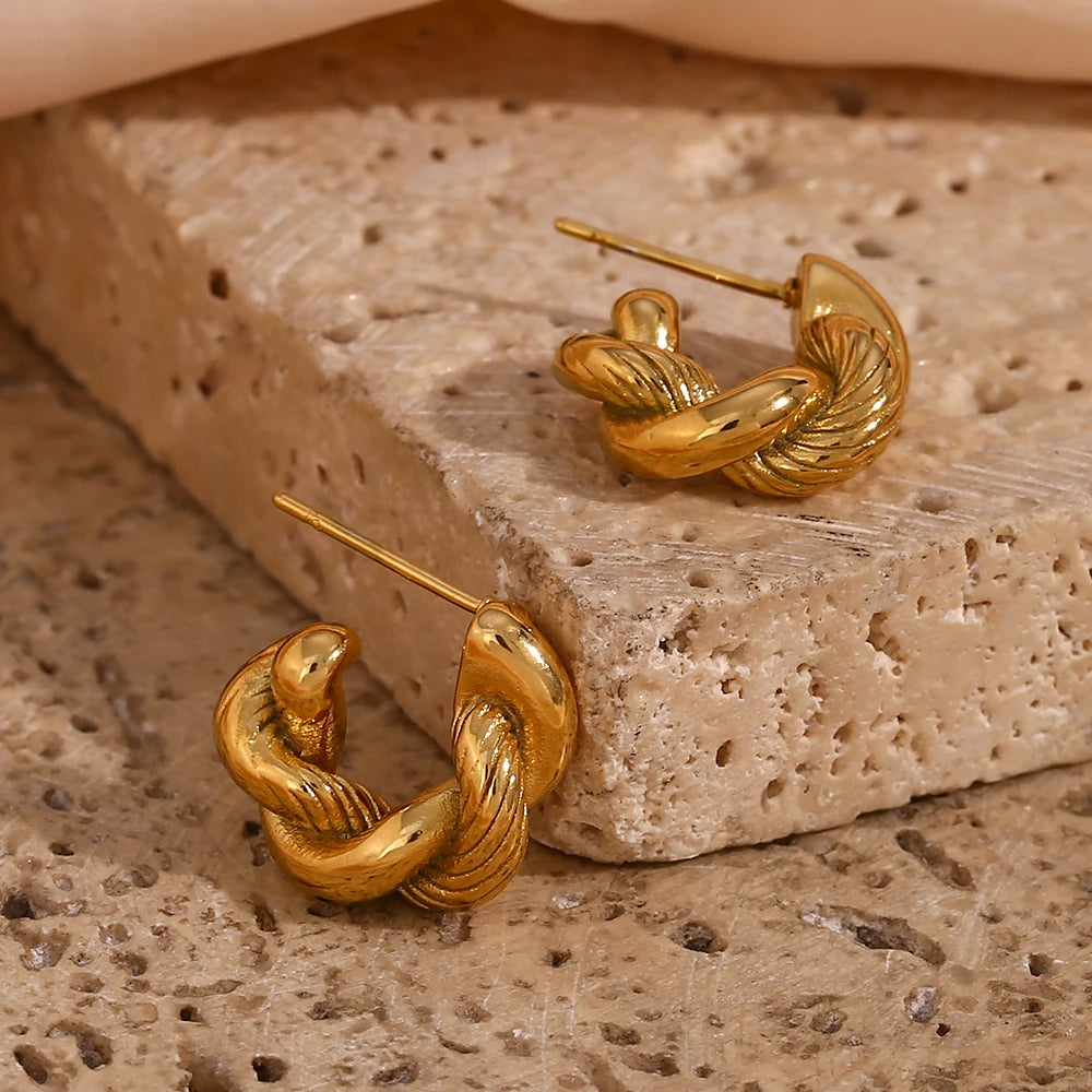 A pair of small, 18K gold plated twisted hoops earrings.