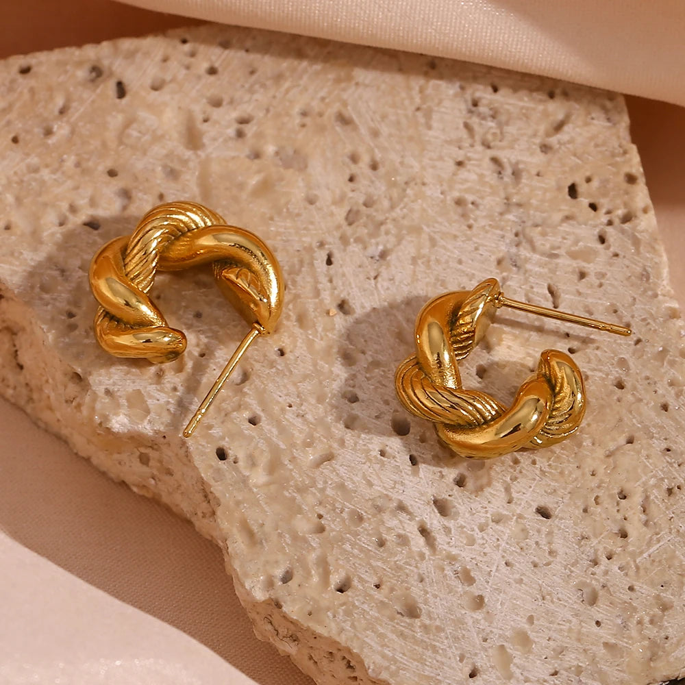 A pair of small, 18K gold plated twisted hoops earrings.