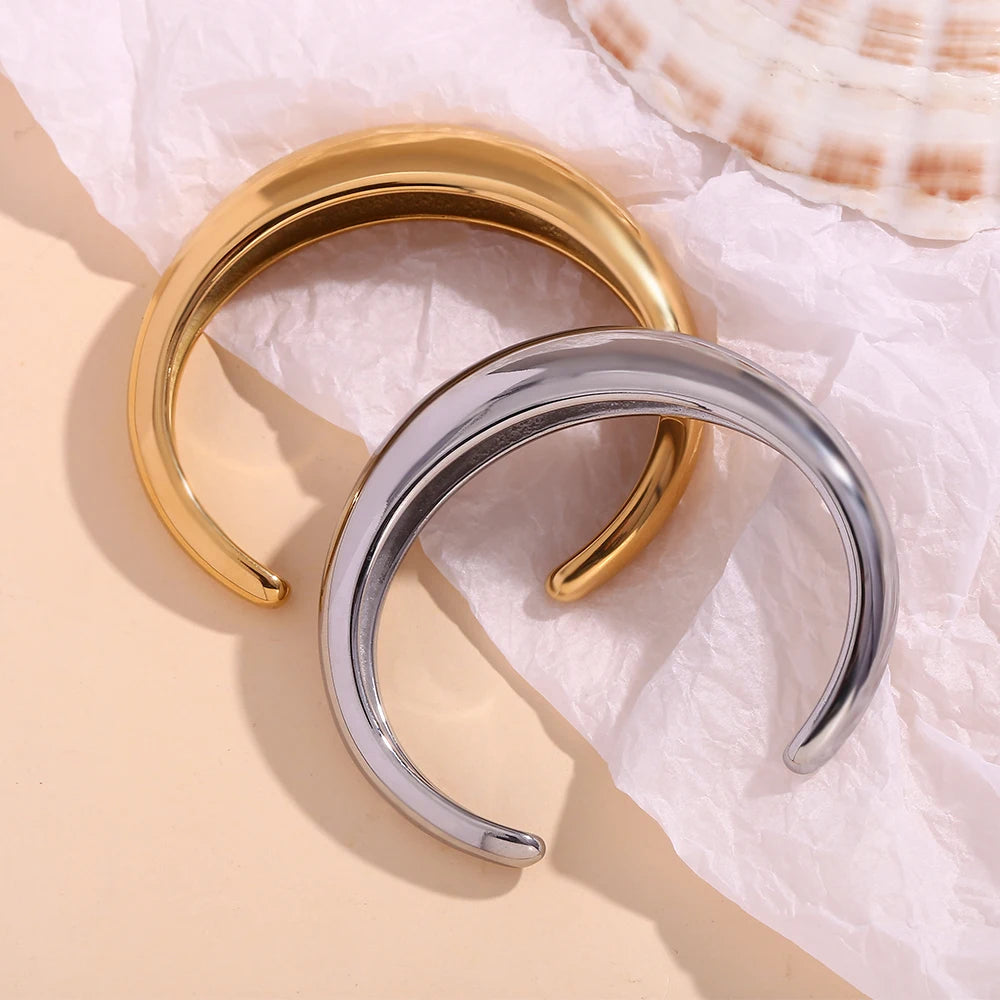 A sleek, gold and silver statement bangle bracelet with a polished finish