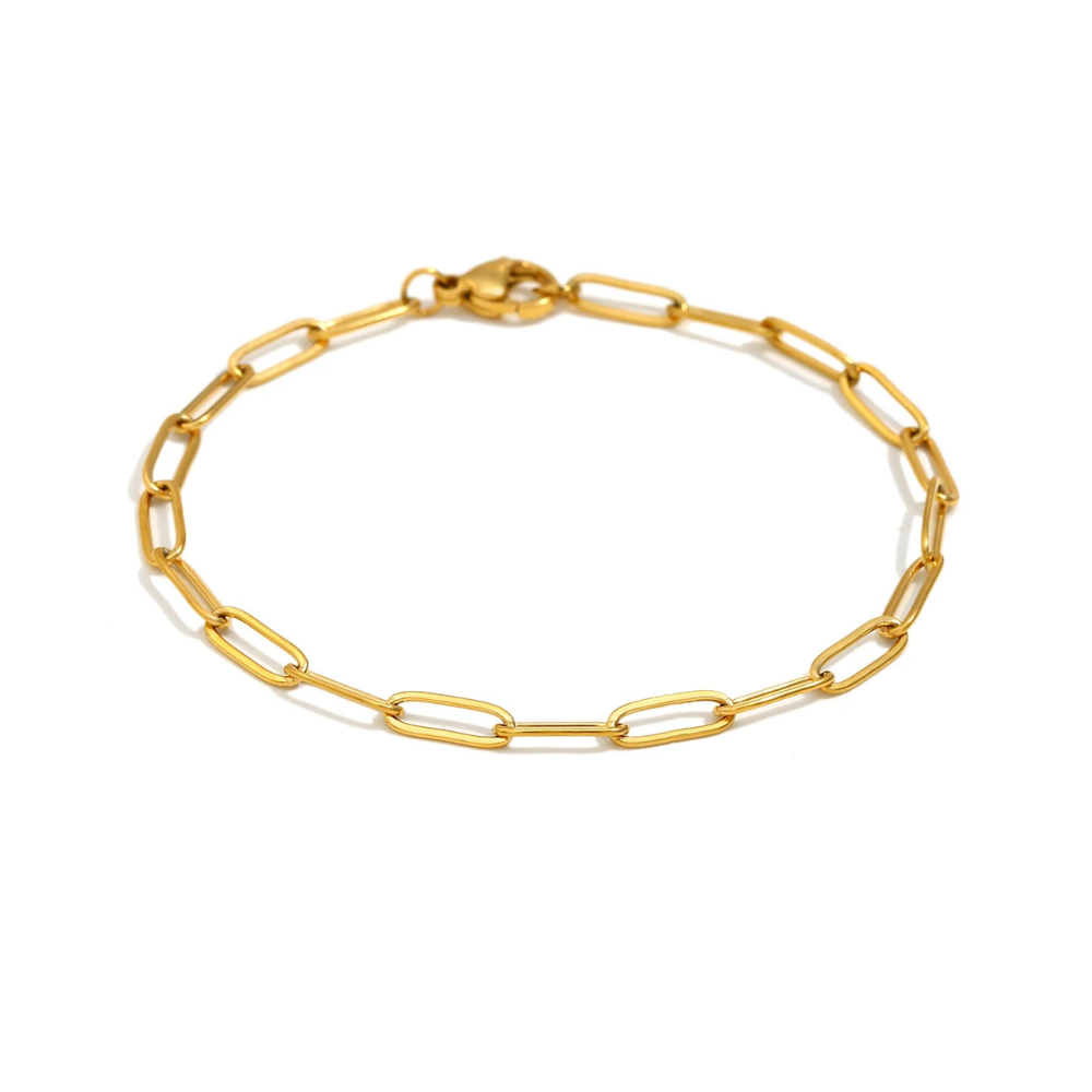 Gold paperclip chain bracelet on a white background