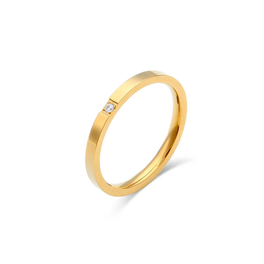 Gold thin ring with a small diamond on a white background