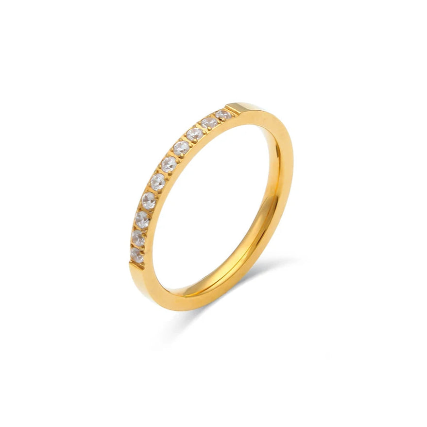 Gold ring with small diamonds on a white background
