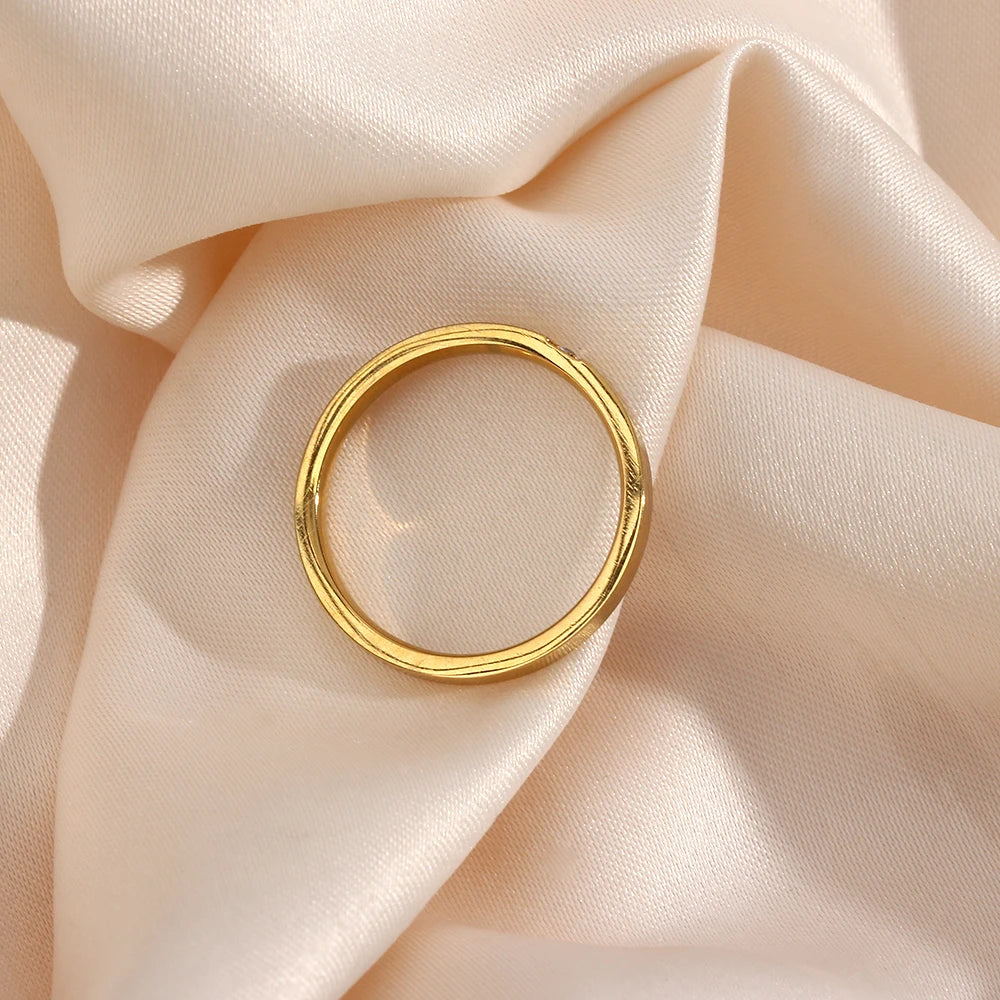 Gold ring on a soft beige fabric background