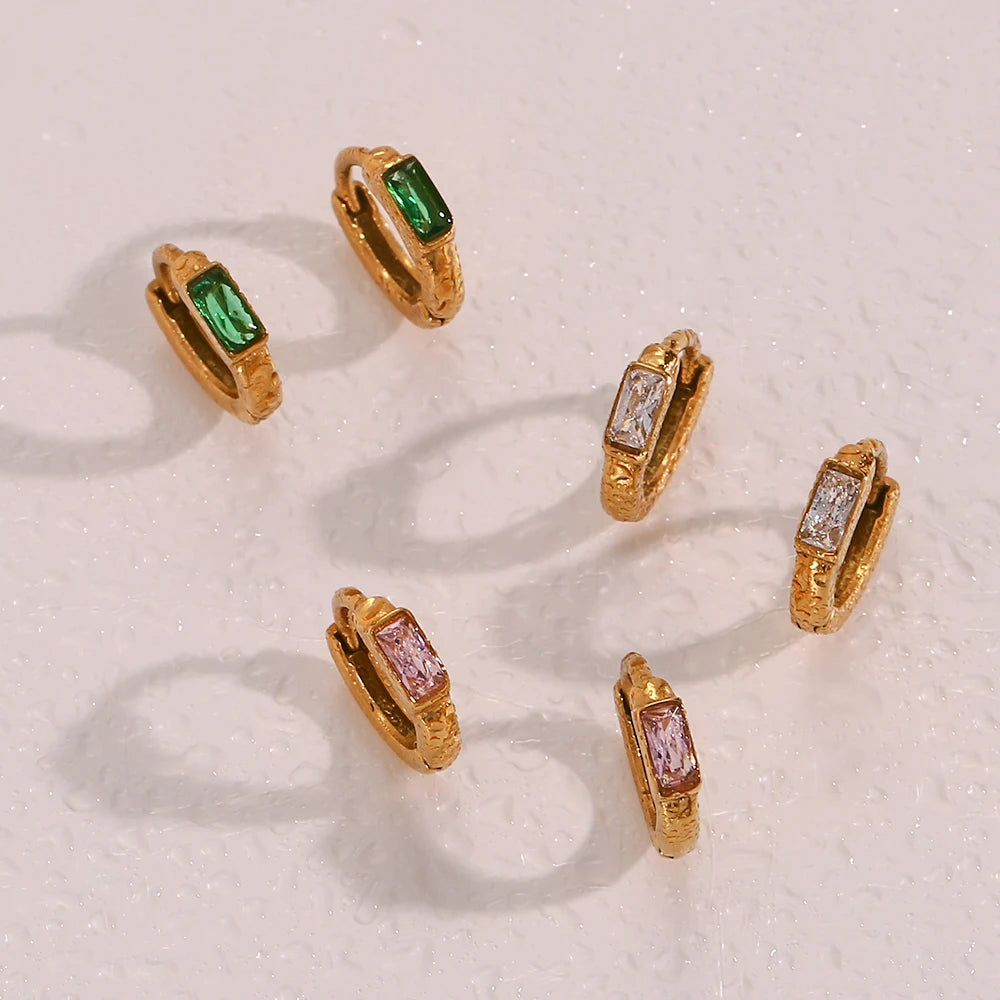 waterproof hoop earrings with gemstones on a light background