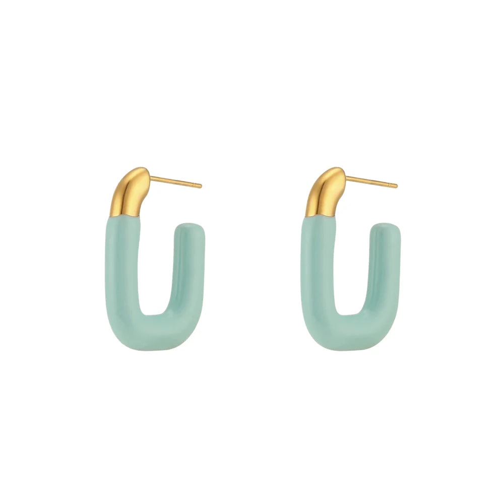 A pair of gold-colored hoop earrings with a pastel blue coating.