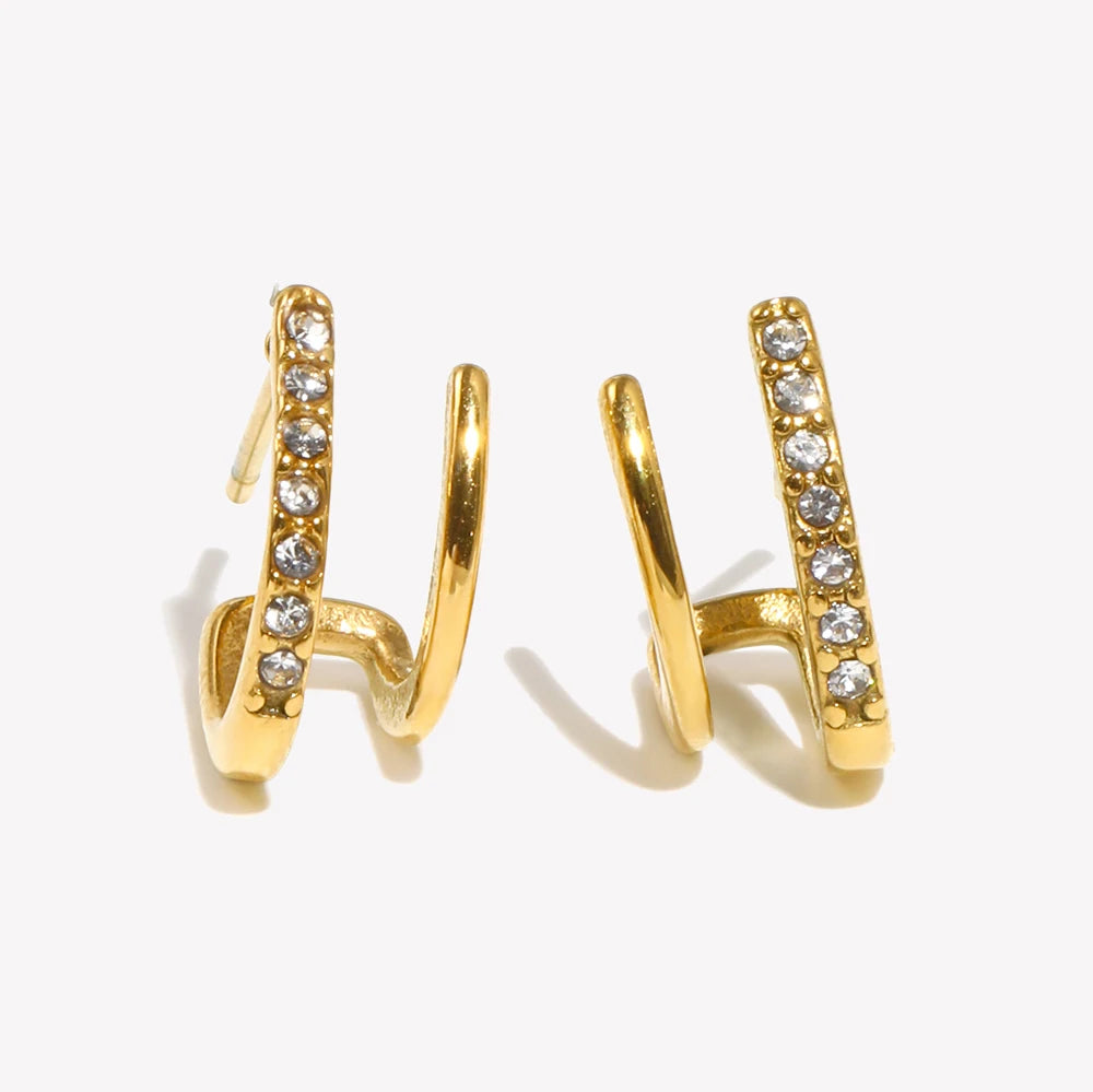 Gold hoop earrings with embedded crystals on a white background