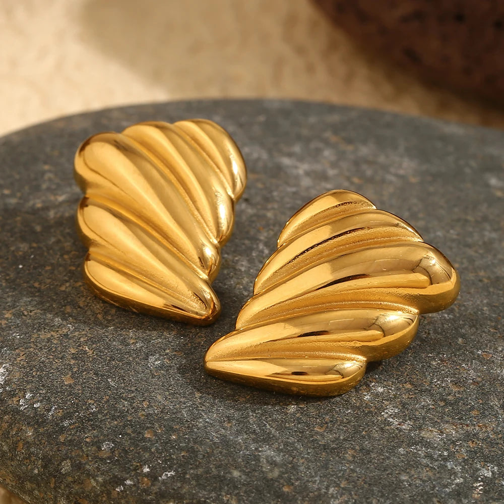 A pair of 18K gold plated stainless steel earrings with a sculpted, wave-like design.