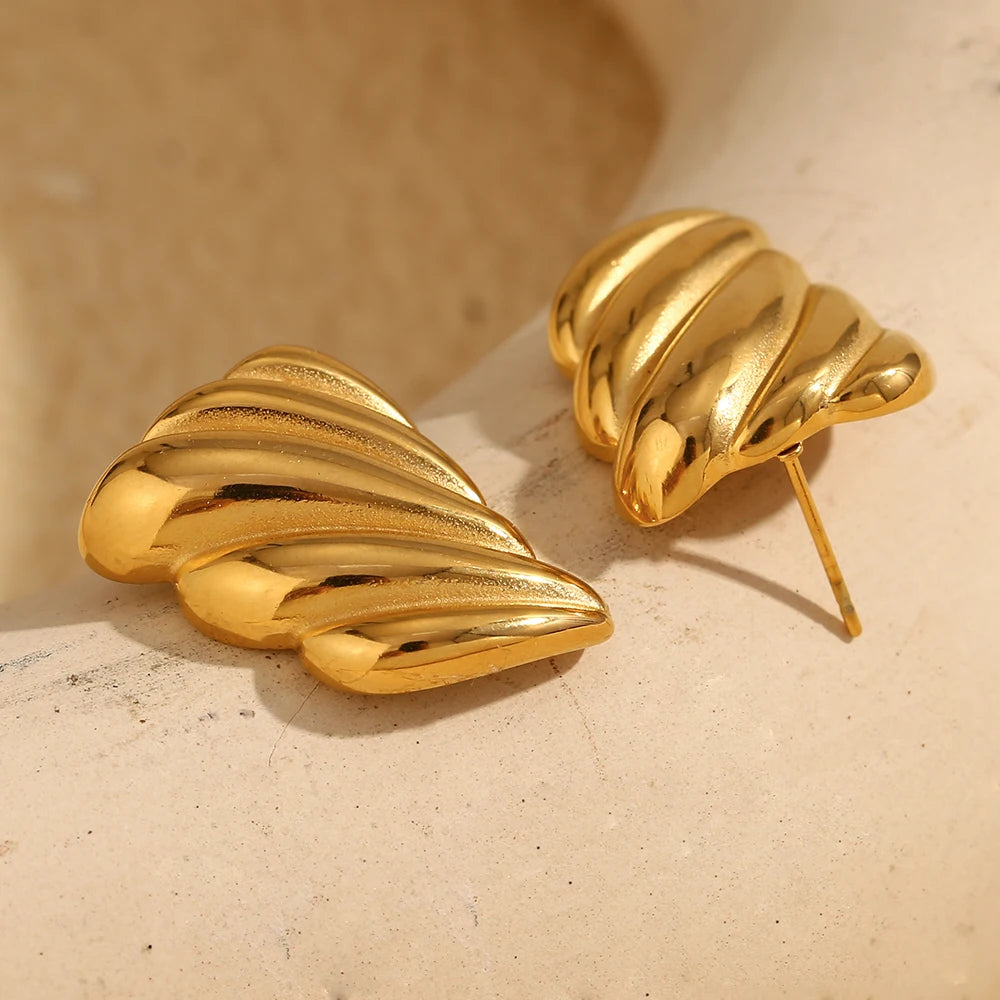 A pair of 18K gold plated stainless steel earrings with a sculpted, wave-like design.