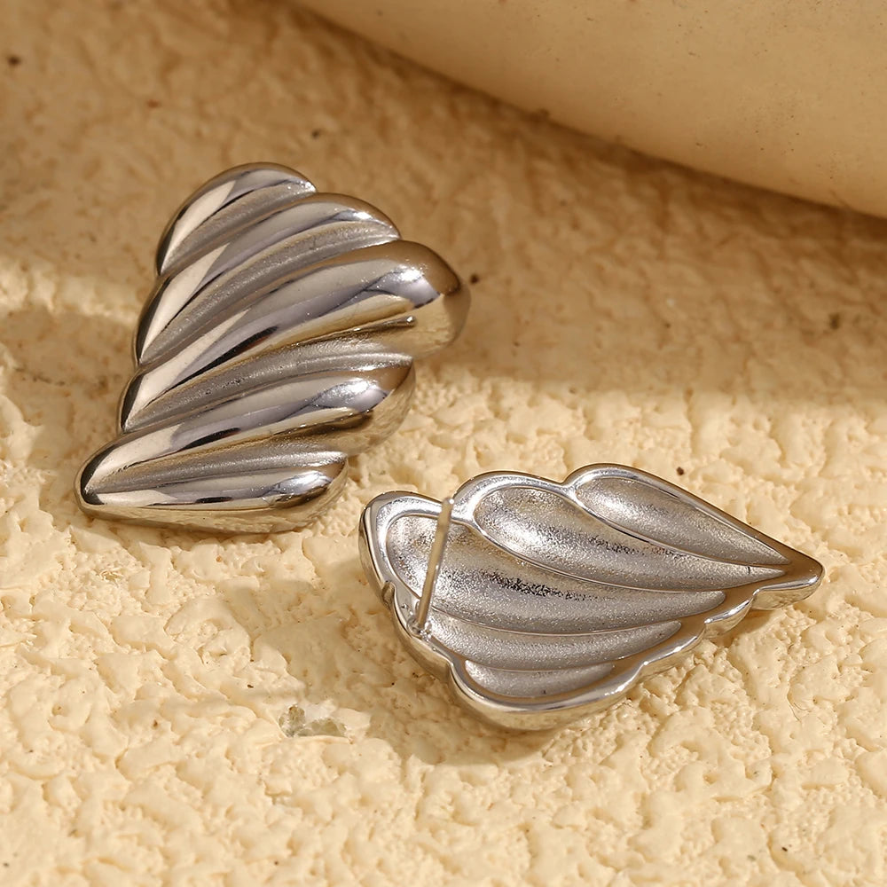A pair of silver stainless steel earrings with a sculpted, wave-like design.