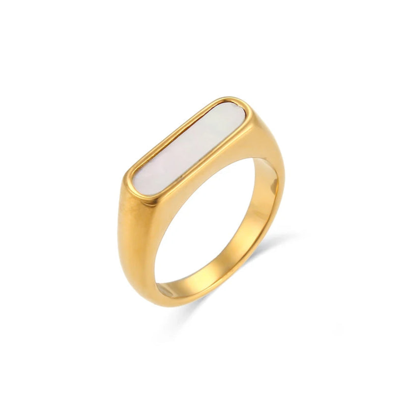 A gold-coated stainless steel ring with a white shell inset, designed in a minimalist style.