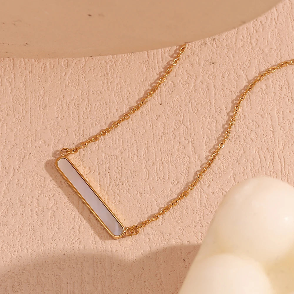 A gold-plated stainless steel necklace with a rounded bar pendant, simple and elegant in design.