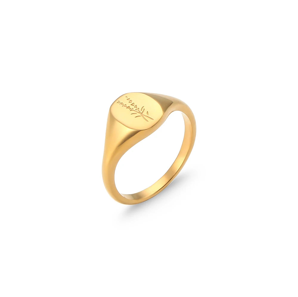 Gold signet ring with engraved text on a white background