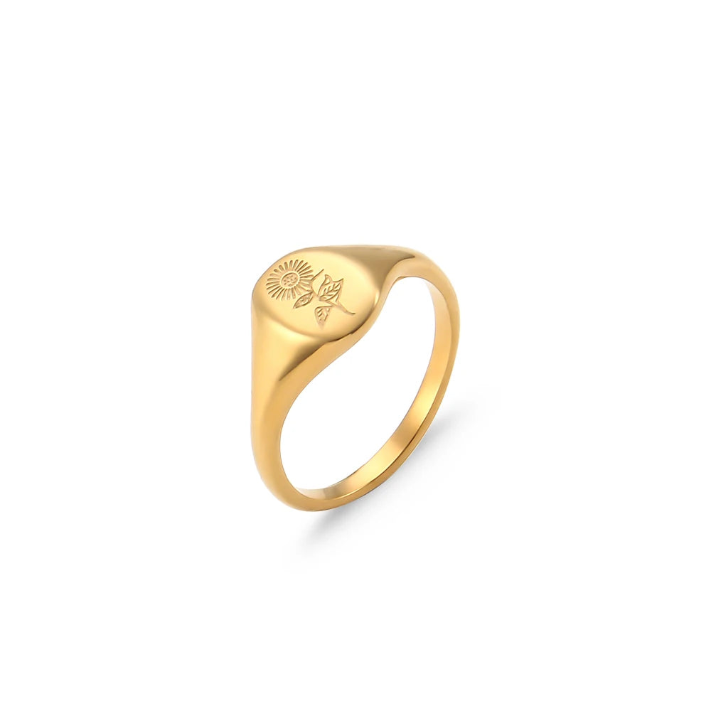 steel signet ring with a engraved design on a white background