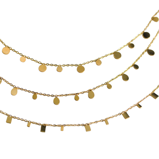 A gold-plated stainless steel necklace with multiple tiny discs attached to a chain, creating a shimmering effect.