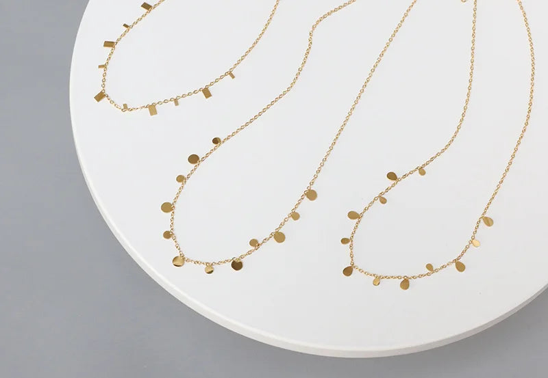 gold-plated stainless steel necklaces with multiple tiny discs attached to a chain, creating a shimmering effect.