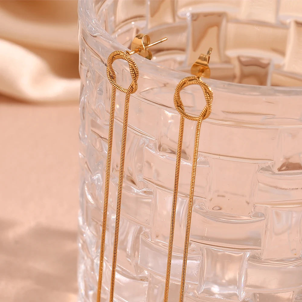Glowline Earrings displayed on glass
