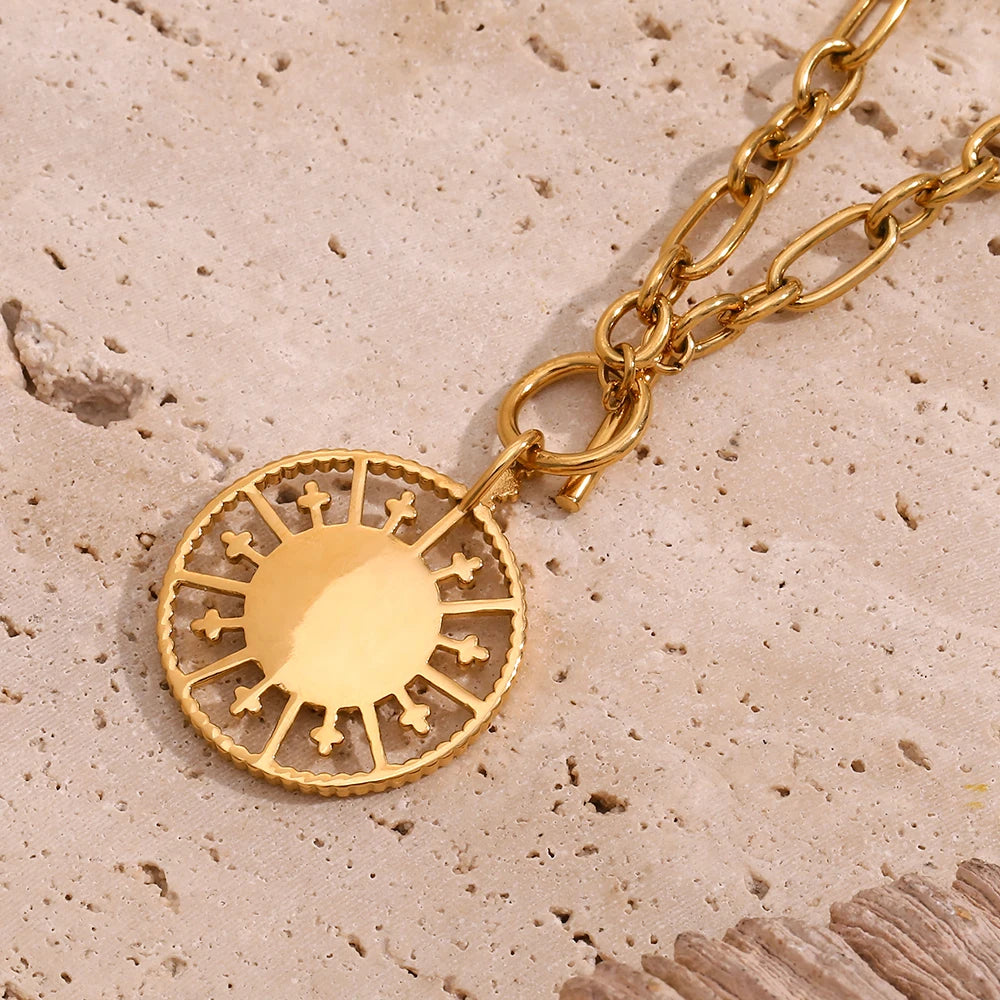 A stainless steel gold chunky necklace with a circular pendant photographed from the back