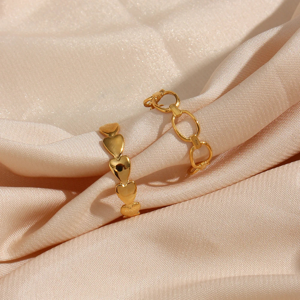 An adjustable gold ring with a minimalist linked design on fabric