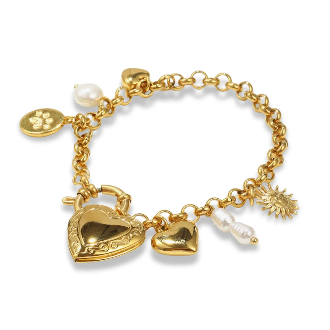 Gold bracelet with heart lock charm, pearl, and other charms on a white background