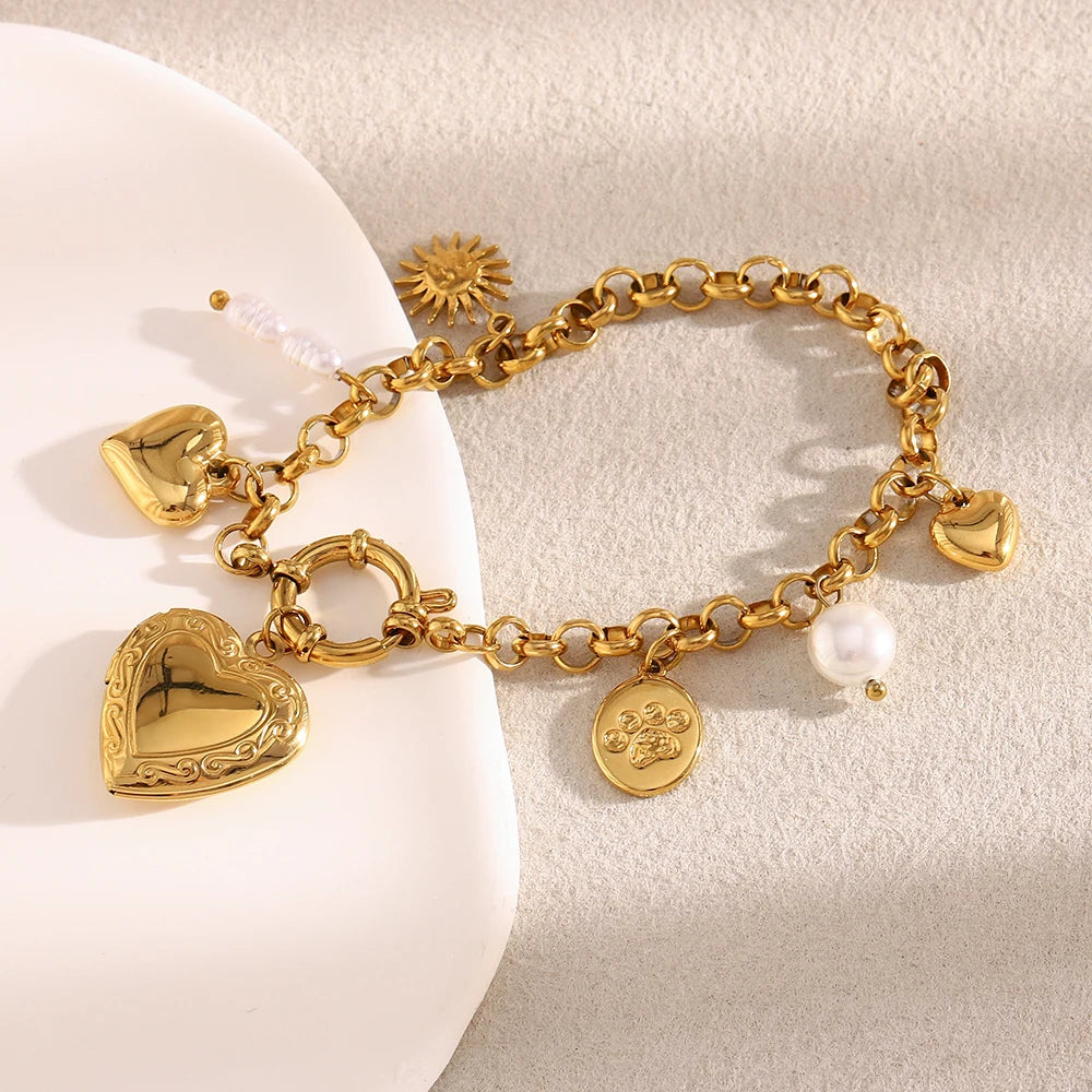 Gold bracelet with heart charms on a light background