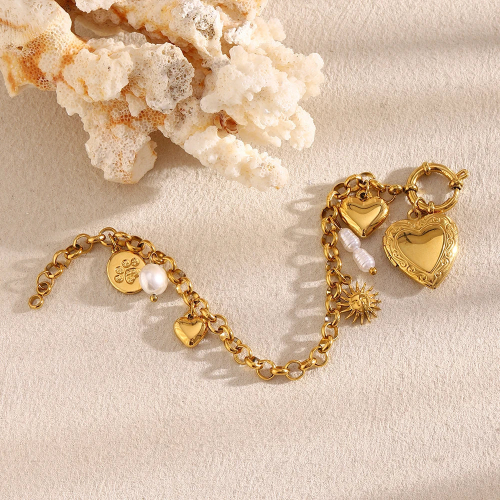 Gold bracelet with heart-shaped charms on a beige background