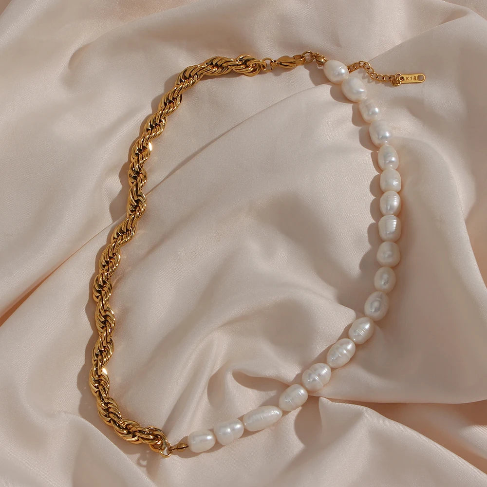 Gold chain and pearl necklace on a soft fabric background