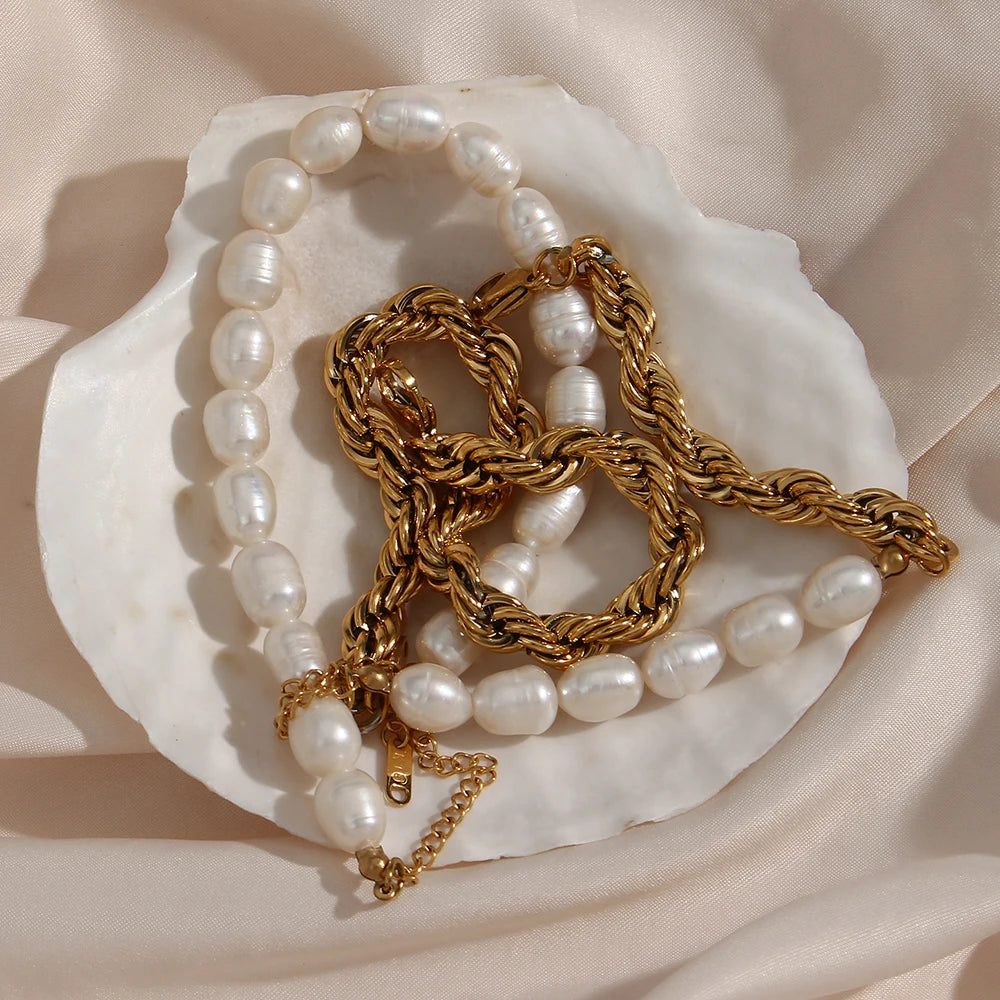 Pearl necklace and gold chain on a seashell with a soft beige background