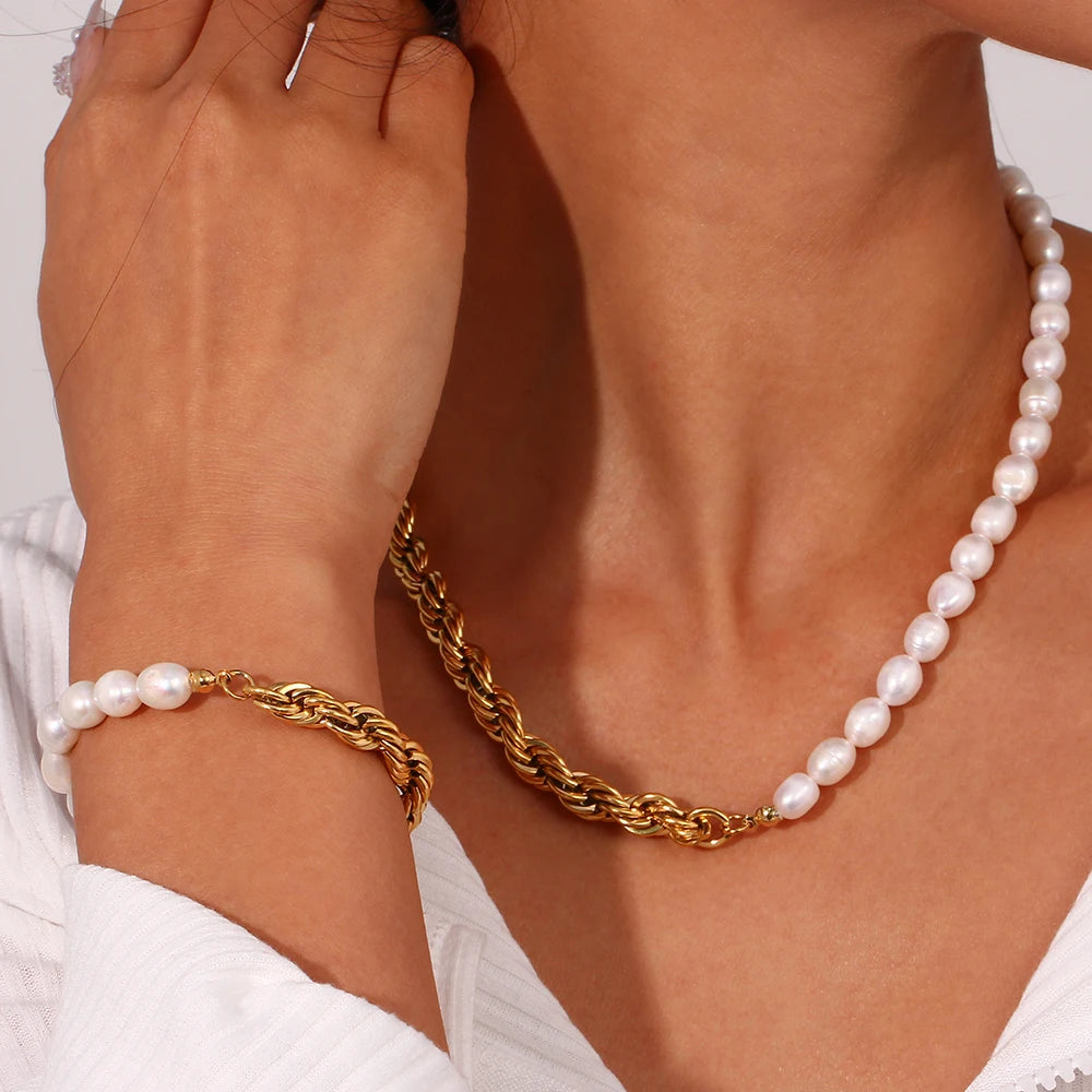 Stainless steel Gold twisted chain bracelet and pearl necklace on a person's wrist and neck against a neutral background