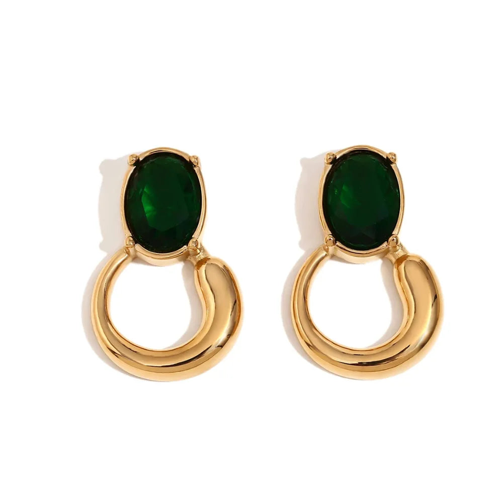 A pair of gold-colored earrings with deep green or black oval stones set in a loop design.