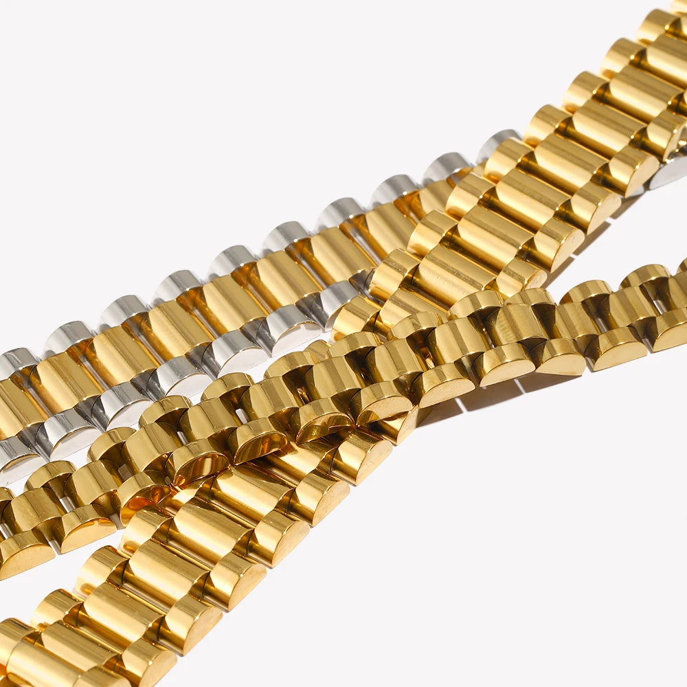 Gold and silver watch strap bracelets on a white background