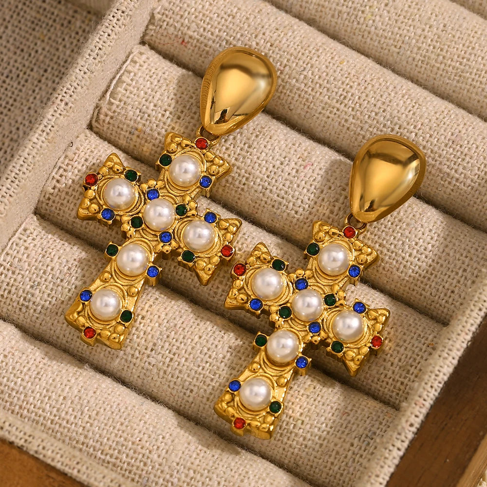 A pair of gold-plated earrings in the shape of a cross, adorned with multicolored zirconia and pearls.