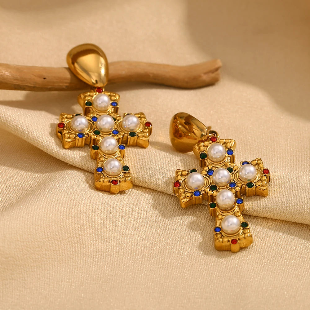 A pair of gold-plated earrings in the shape of a cross, adorned with multicolored zirconia and pearls.
