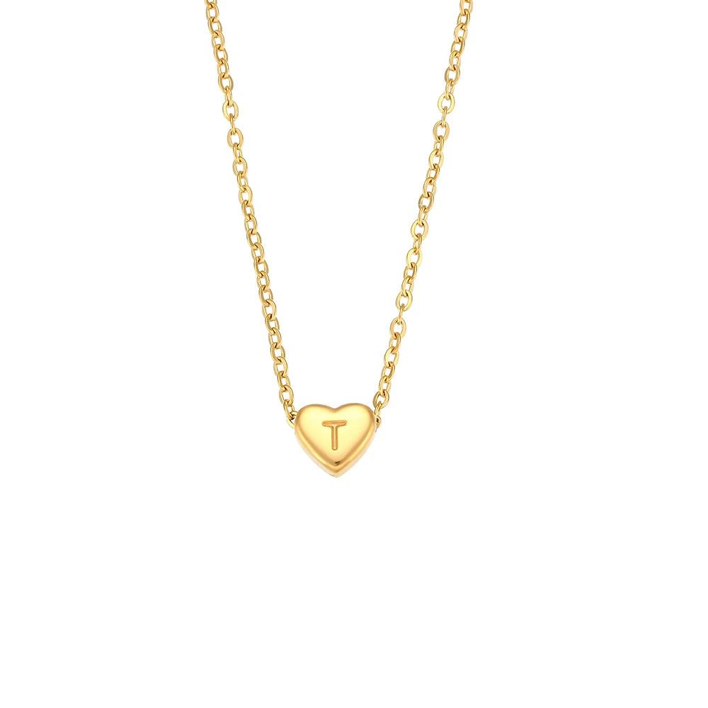 Gold necklace with a heart-shaped pendant featuring the letter 'T' on a white background