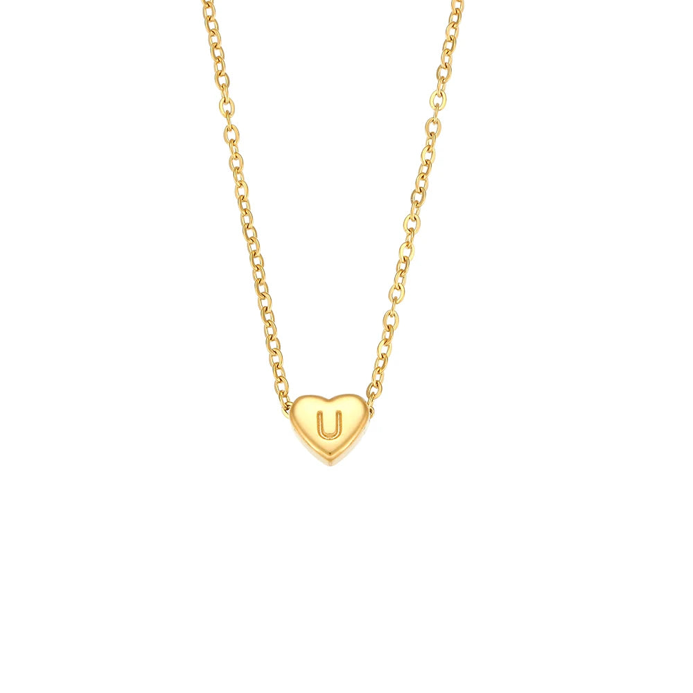 Gold necklace with a heart-shaped pendant featuring the letter 'U' on a white background